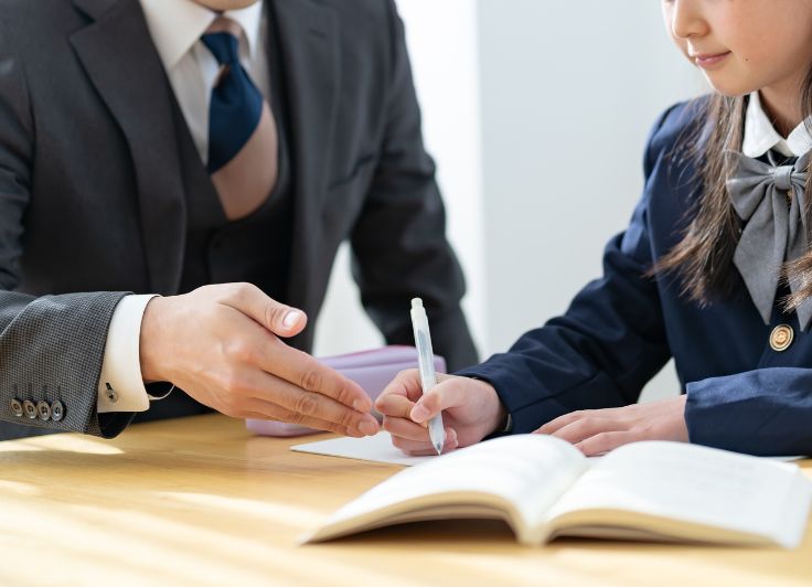 勉強している女子学生と教師