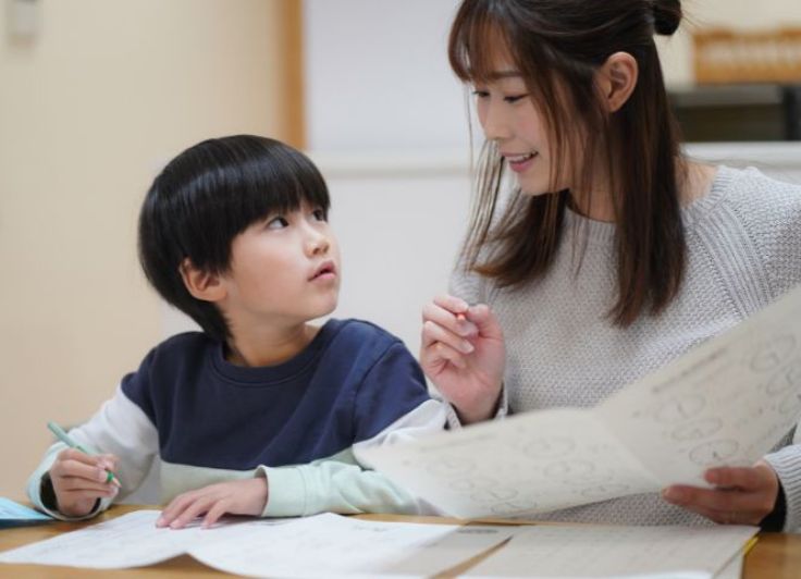 子どもの勉強を見る母親